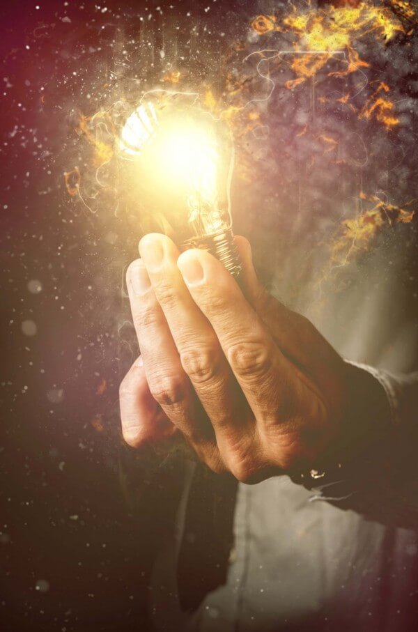 Person Holding a Lightbulb with Flare